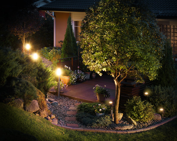 This is a picture of one of our clients backyard where we installed landscape lighting. After the installation it created a nice ambiance. 