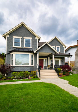 This is a picture of a detached home in Cloverdale which received landscaping services in the front lawn.